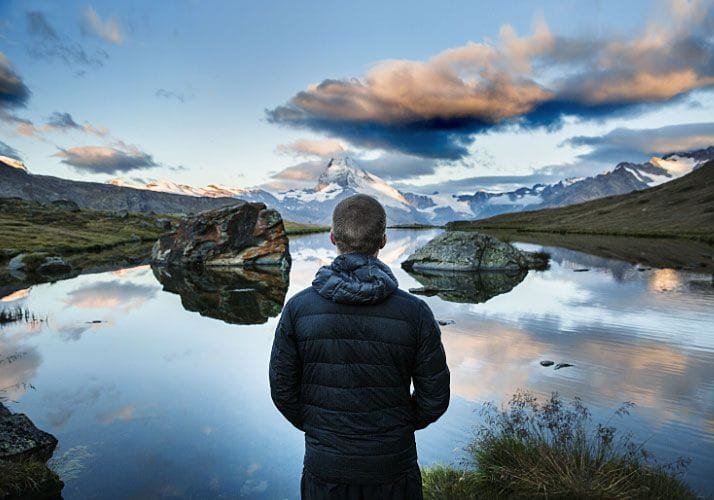 Man Standing at Lake